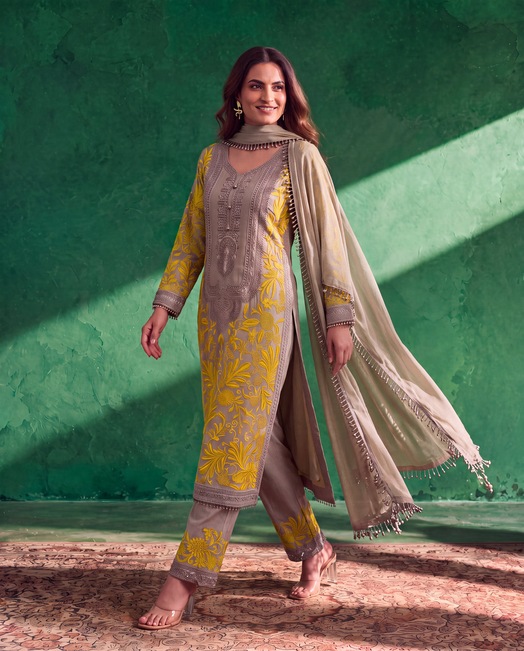 Grey dupatta with decorative tassels and elegant finishing details.