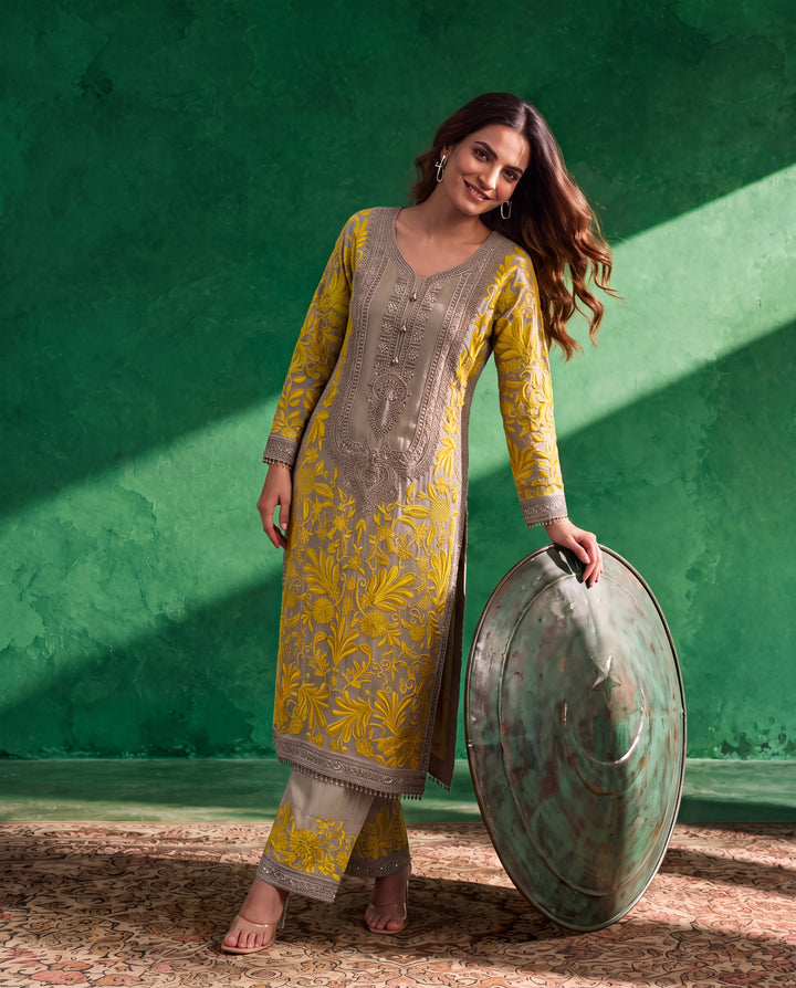 Grey georgette Pakistani suit with mustard yellow resham jaal embroidery and silver embellished neckline.