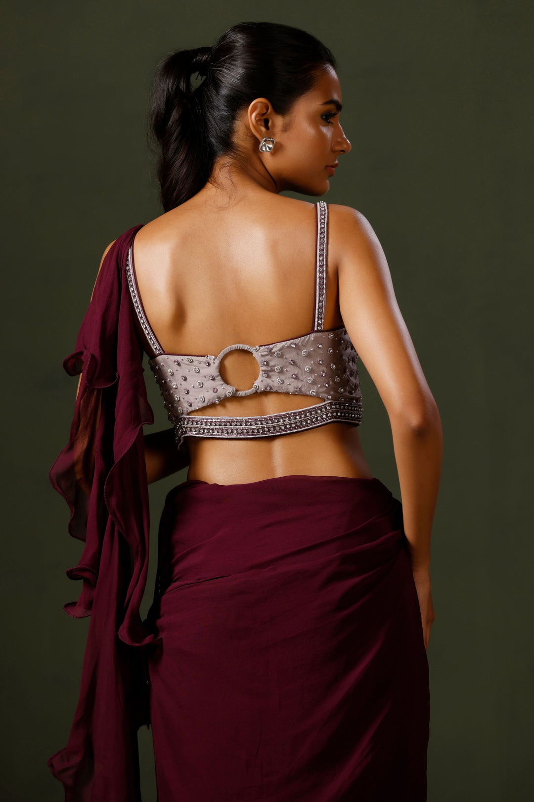 Purple Draped Saree with A Pearl Chain Blouse