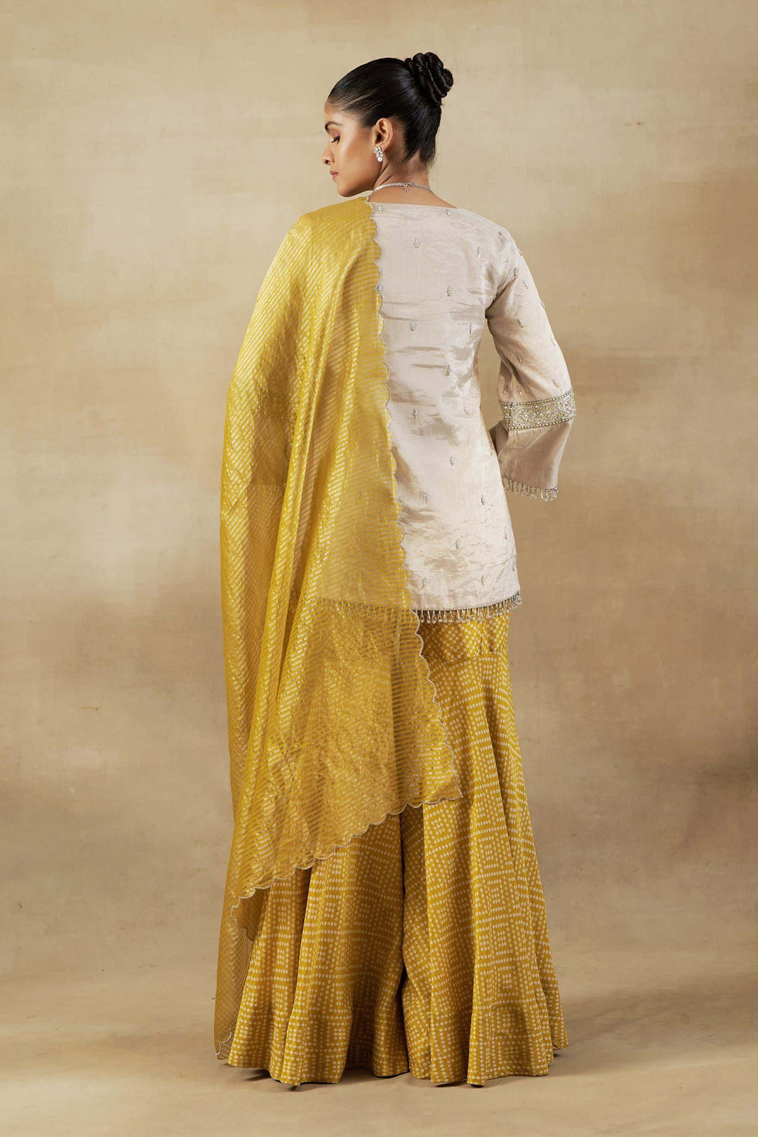 Silver Tissue Short Kurta with Mustard Bandhani Garara and Gold Self Weave Zari Dupatta